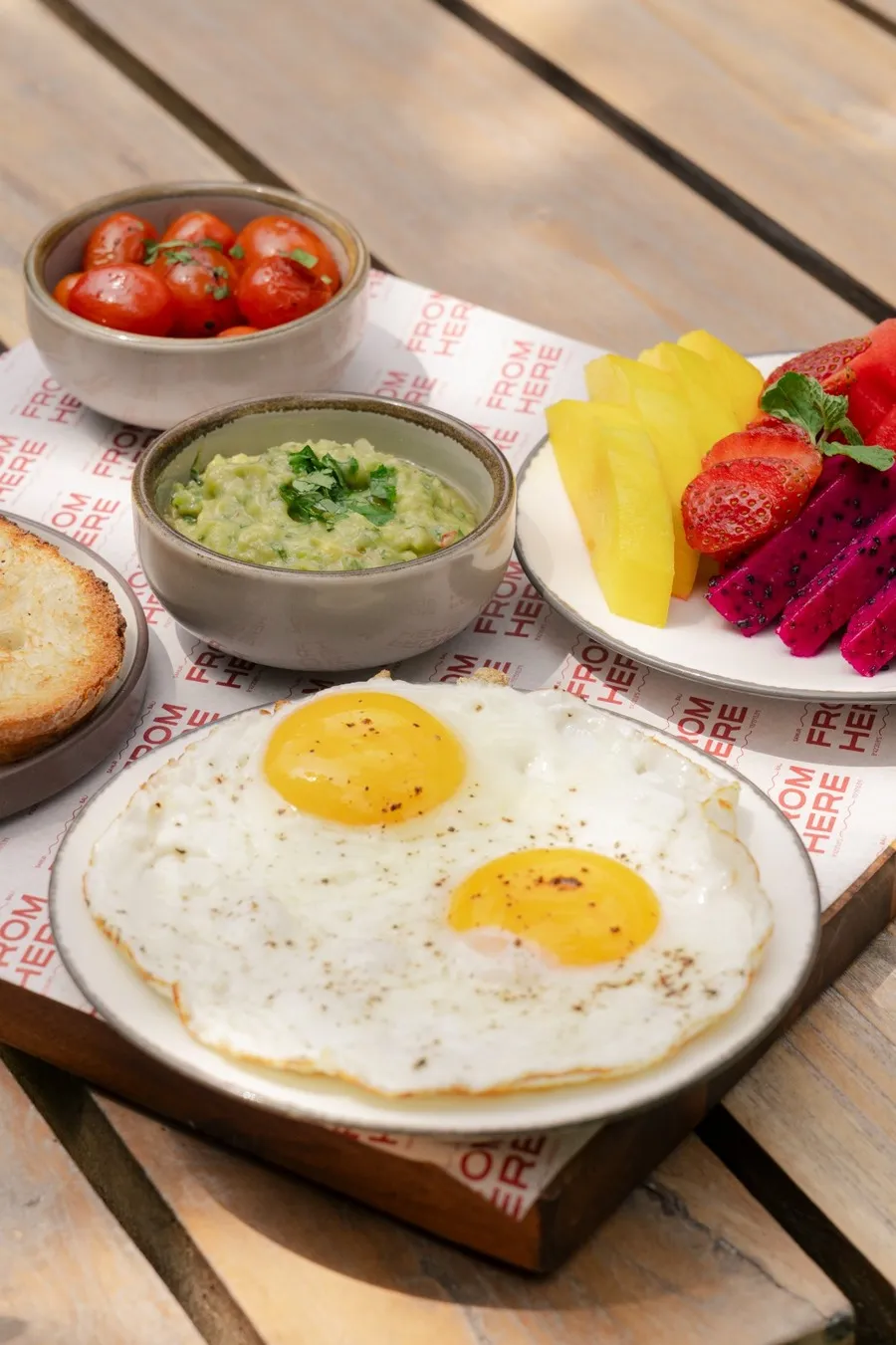 Breakfast spread with fried eggs and fresh fruits