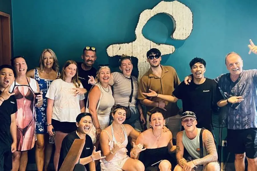 Group smiling together in front of Frankies logo