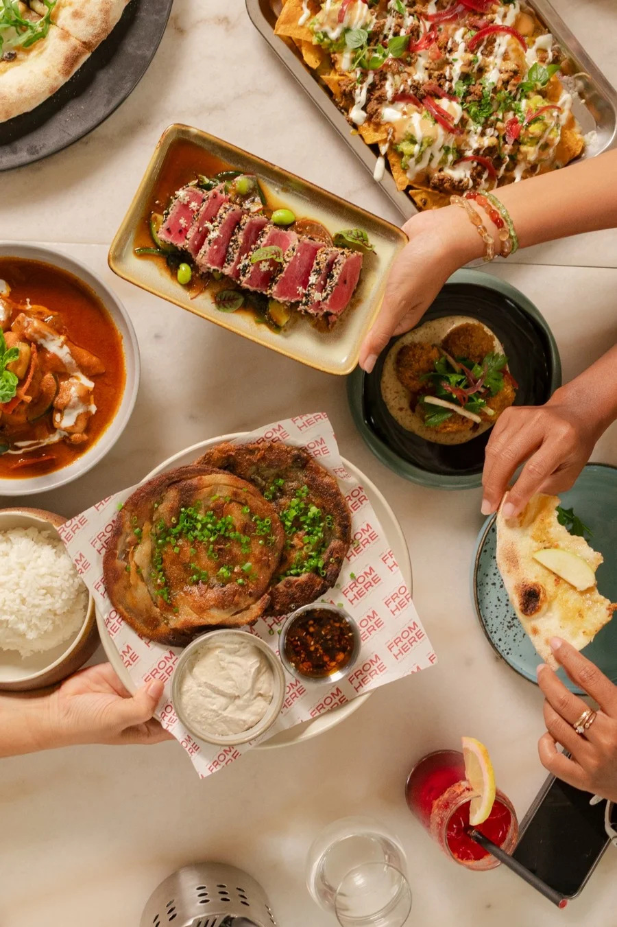 People sharing restaurant dishes